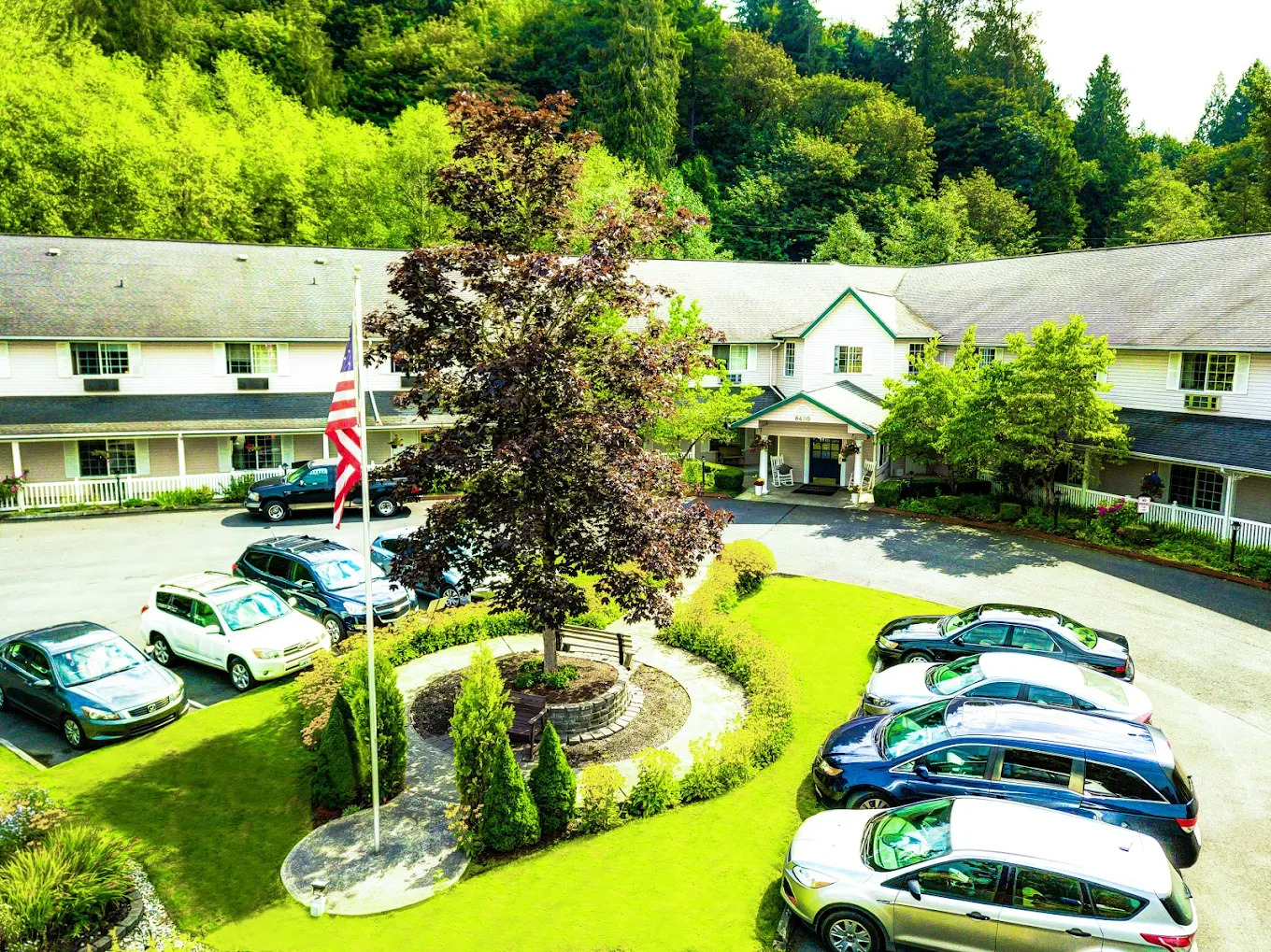 Front courtyard seen from an upper window, with the circular drive, the flag and the copper beech